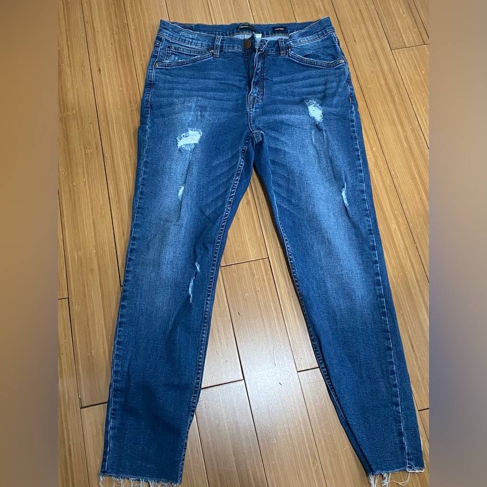 Distressed blue denim skinny jeans.